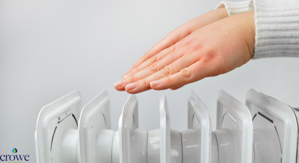 hand of a white female over a radiator getting warm